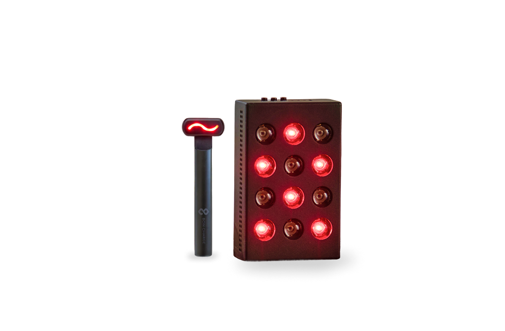 Mini red light device, glowing red, next to a red light face wand
